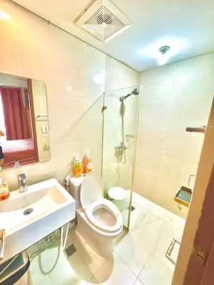 a bathroom with a toilet and a shower and a sink at 1 Bedroom Unit terminal 3 Airport By ASD Condotel in Manila