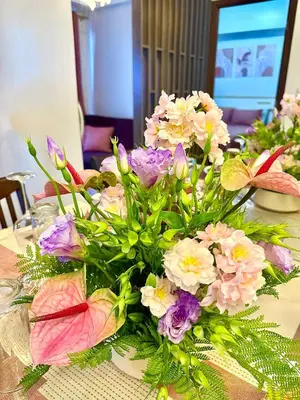a vase filled with flowers on a table at 1 Bedroom Unit terminal 3 Airport By ASD Condotel in Manila