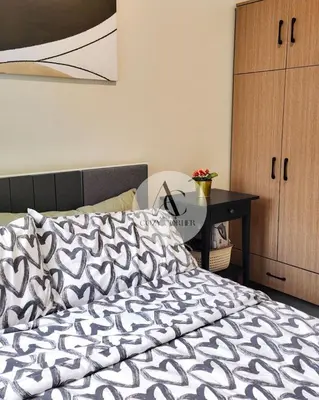 a bedroom with a bed and a desk with a bed sidx sidx at Cozy staycation 1BR with WiFi, Netflix and more at Shore 3 MOA by Angels Cozy Corner in Manila