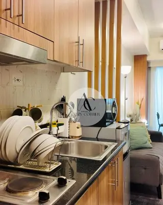 a kitchen with a sink and a counter top at Cozy staycation 1BR with WiFi, Netflix and more at Shore 3 MOA by Angels Cozy Corner in Manila