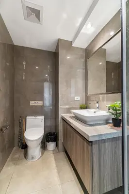 a bathroom with a toilet and a sink and a mirror at Elegant Studio City View near Airport, City of Dreams, Okada, Solaire, PARQAL, Ayala Malls, and MOA in Manila