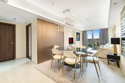 a dining room and living room with a table and chairs at Elegant 2BR City View near City of Dreams, Okada, Solaire, PARQAL, Ayala Malls, MOA, and Airport in Manila