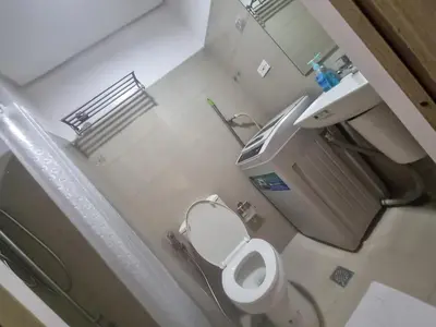 a small bathroom with a toilet and a sink at Cozy Bedroom at SM MOA Sunset View by Manila Bay in Manila