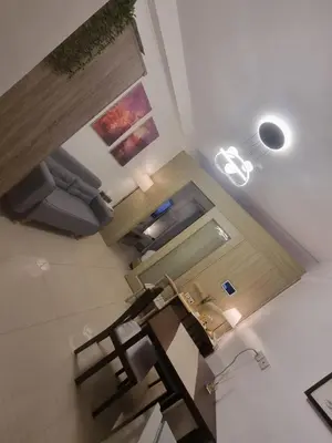 an overhead view of a living room with a table and chairs at Cozy Bedroom at SM MOA Sunset View by Manila Bay in Manila