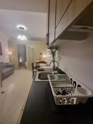 a kitchen with a sink and a counter top at Cozy Bedroom at SM MOA Sunset View by Manila Bay in Manila