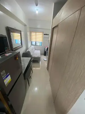 a living room with a couch and a table at Leaf Residences in Muntinlupa