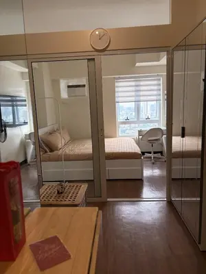 a small room with two beds and a mirror at New 1BR Condo at The Camden Place Near DLSU Manila in Manila