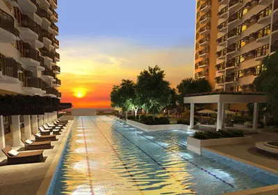 a large swimming pool in the middle of a building at Bayfront Suite in Pasay, With Balcony, Manila Bay View, Near MOA, OKADA, PICC, Airport, WFH ready Free pool access Gym and Sauna in Manila