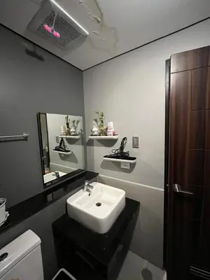 a bathroom with a sink and a mirror at Bayfront Suite in Pasay, With Balcony, Manila Bay View, Near MOA, OKADA, PICC, Airport, WFH ready Free pool access Gym and Sauna in Manila