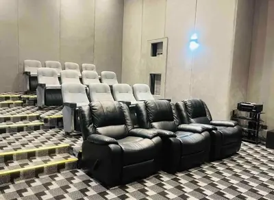a room with chairs and a leather reclining couch at Family Condotels by Gerry in Manila