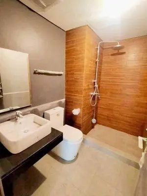 a bathroom with a toilet and a sink and a shower at Family Condotels by Gerry in Manila