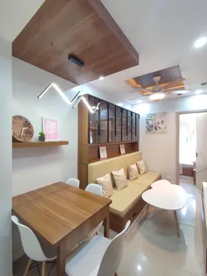 a living room with a couch and a table and chairs at Bloom Residences Tower A Entire 2 BR Condominium in Paranaque in Manila