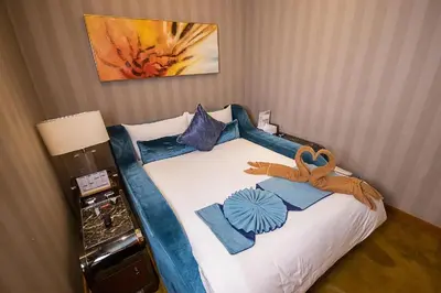 a bed in a hotel room with a bedspread with at Yatai Spa in Manila
