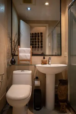 a bathroom with a toilet and a sink at Wabi-Sabi Stay at Knightsbridge Residences in Manila