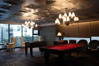a room with a pool table and chairs at Wabi-Sabi Stay at Knightsbridge Residences in Manila