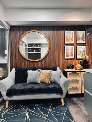 a living room with a couch and a mirror at Azure Residence by Ibiza Homes in Manila