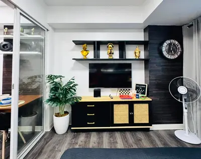 an office with a desk with a computer and a clock at Azure Residence by Ibiza Homes in Manila