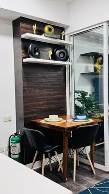 a dining room table with black chairs in a room at Azure Residence by Ibiza Homes in Manila
