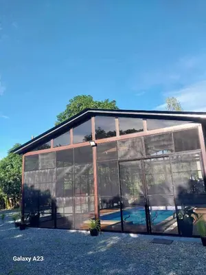 a glass building with a lot of windows at Sehaliah Agricultural Farm Resort in Amadeo