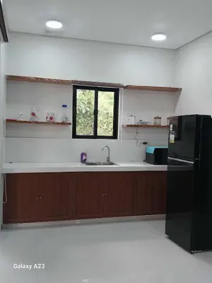 a kitchen with a sink and a black refrigerator at Sehaliah Agricultural Farm Resort in Amadeo