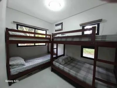 two bunk beds in a room with two windows at Sehaliah Agricultural Farm Resort in Amadeo