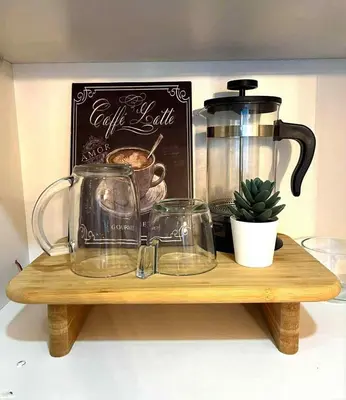 a wooden shelf with a coffee pot and glasses on it at Guest House Ground Zero in Manila