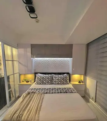a large bed in a room with a window at Guest House Ground Zero in Manila