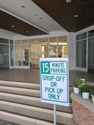 a parking sign in front of a building at 3BR, 5 Beds, With Pool, Wifi, Netflix, Parking in Manila
