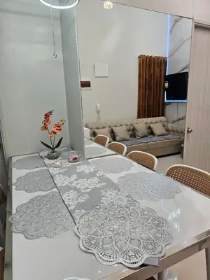 a dining room with a table and a couch at 3BR, 5 Beds, With Pool, Wifi, Netflix, Parking in Manila