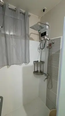 a shower stall in a bathroom with a shower curtain at 3BR, 5 Beds, With Pool, Wifi, Netflix, Parking in Manila