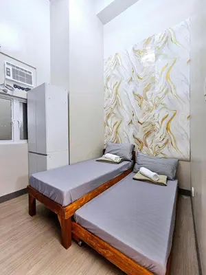 a room with two beds and a wall at 3BR, 5 Beds, With Pool, Wifi, Netflix, Parking in Manila