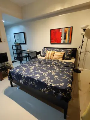 a bedroom with a bed and a dining room at Lowest Room Rate in Makati with fast wifi & view in Manila