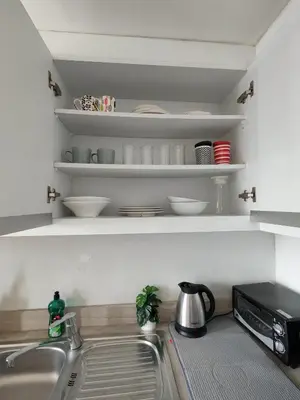 a kitchen counter with a sink and a microwave at Lowest Room Rate in Makati with fast wifi & view in Manila
