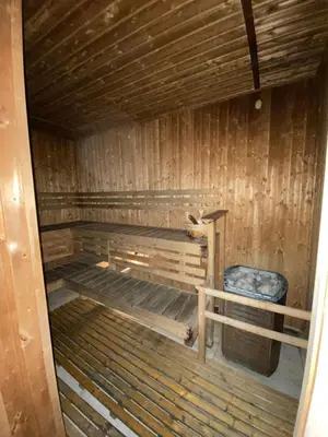 an inside view of a wooden sauna with a bench at Lowest Room Rate in Makati with fast wifi & view in Manila