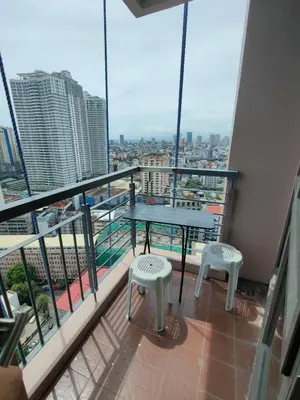 a balcony with a table and two stools at Lowest Room Rate in Makati with fast wifi & view in Manila