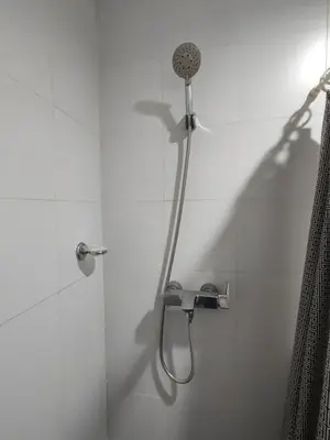 a shower with a shower head in a bathroom at Lowest Room Rate in Makati with fast wifi & view in Manila