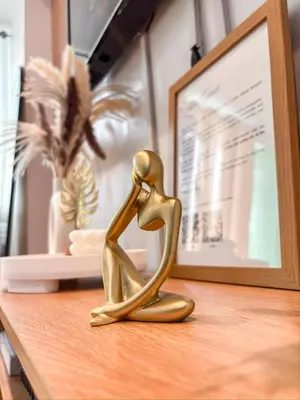 a gold figurine of a couple sitting on a table at Premiere Staycation in Manila