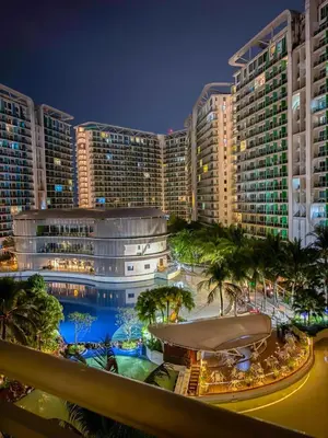 a view of a resort at night with a pool at Premiere Staycation in Manila