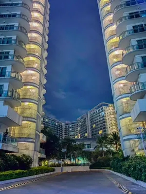 a view of two tall buildings at night at Premiere Staycation in Manila