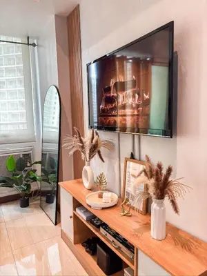 a living room with a television on a wall at Premiere Staycation in Manila