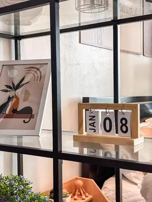 a window with a table with a picture and a sign at Premiere Staycation in Manila