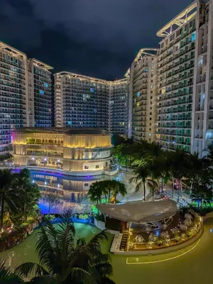 a view of a large building at night at Premiere Staycation in Manila