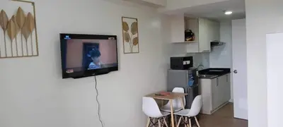 a living room with a television on a wall at Condotels by Versola in Manila