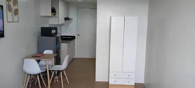 a small kitchen with a table and chairs in a room at Condotels by Versola in Manila
