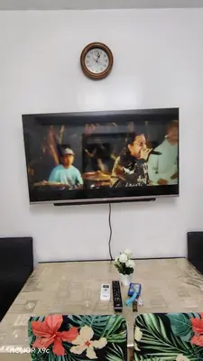 a tv hanging on a wall with a picture on it at Sea Residences condotel in Manila