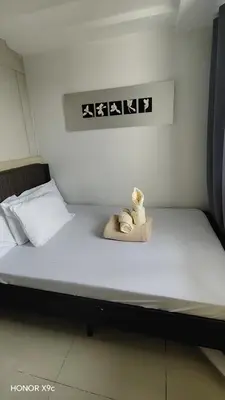 two stuffed animals sitting on top of a bed at Sea Residences condotel in Manila