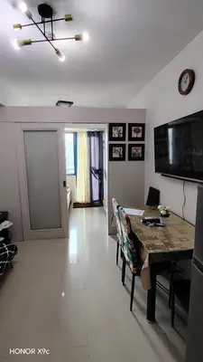 a living room with a dining room table and a living room at Sea Residences condotel in Manila