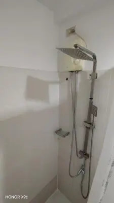 a shower in a bathroom with a shower head at Sea Residences condotel in Manila