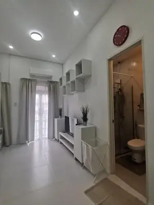 a white bathroom with a toilet and a sink at Ikea inspired home with mini balcony and free parking in Cainta