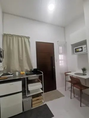 a kitchen with a counter and a table with a sink at Ikea inspired home with mini balcony and free parking in Cainta